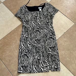 Black and white dress. Length is above knee. Short sleeves.